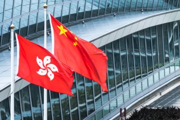 Hong Kong and mainland China national flags stand together