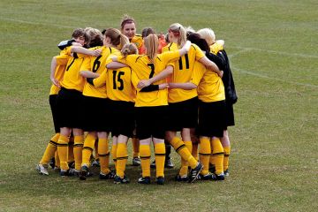 Women`s football team huddle before match Women`s football team huddle before match