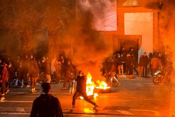 Iranian protestors block a street during a protest in Tehran on January 9
