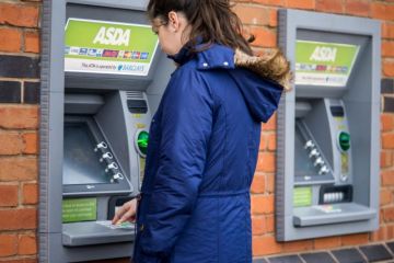 Young adult woman withdrew from cash machine.