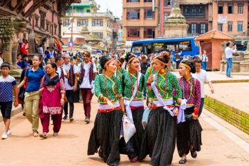 Group of dancers wearing traditional costumes in Patan Durbar Square, Kathmandu Valley,