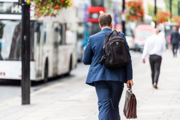 businessman man walking with briefcase and backpack before or after work. businessman man walking with briefcase and backpack before or after work.
