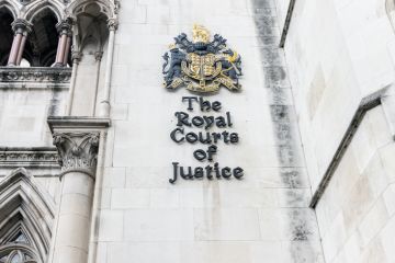rest on the wall of Royal Courts of Justice on the Strand in central London rest on the wall of Royal Courts of Justice on the Strand in central London