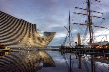 Victoria &Albert Museum Dundee exhibition opening Ocean Liners, Scottish Design museum exterior and ship at dusk.