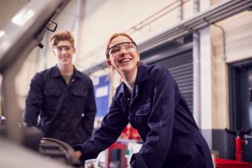 Students looking at car engine on auto mechanic apprenticeship course Students looking at car engine on auto mechanic apprenticeship course