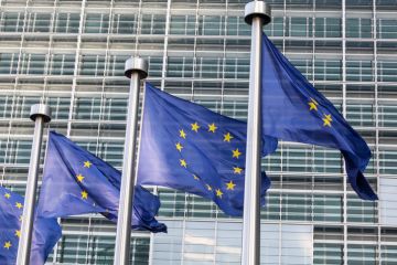 EU flags outside European Parliament building, Brussels