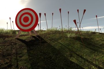 An archery target surrounded by arrows stuck in the ground An archery target surrounded by arrows stuck in the ground