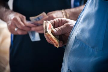 Hand of a person holding money banknotes Hand of a person holding money banknotes