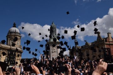 Graduates receive their diplomas in a ceremony at Hull City Hall, UK