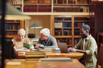 Several people studying in a library