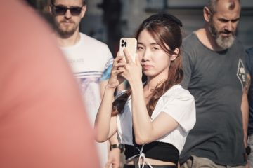 Happy smiling tourists strolling and taking pictures on the famous Charles Bridge in Prague. Happy smiling tourists strolling and taking pictures on the famous Charles Bridge in Prague.
