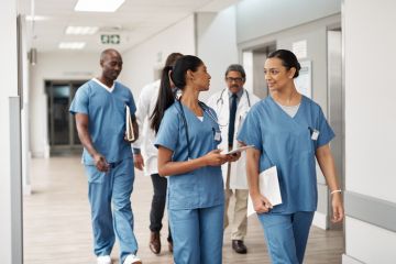 Doctors walking through hospital wearing scrubs