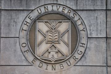 On the wall at the entrance to St Leonard's Land in Holyrood Road, the coat of arm of the University of Edinburgh