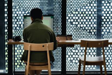 A man uses whatsapp on a computer belonging to the jakarta library. A man uses whatsapp on a computer belonging to the jakarta library.