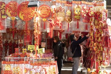 To celebrate the coming Chinese New Year outdoor shopping stalls place red goods representing luck for sale. To celebrate the coming Chinese New Year outdoor shopping stalls place red goods representing luck for sale.