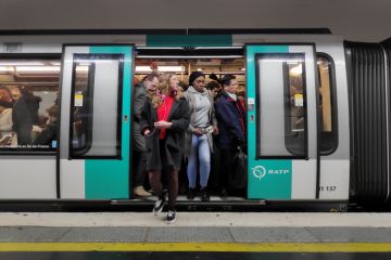 Commuters in a crowded metro train in the Paris metro.