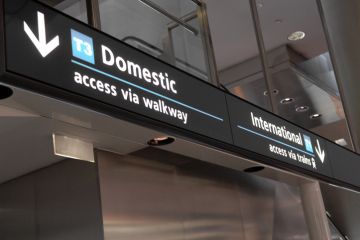 Airport sign pointing to domestic and international departures