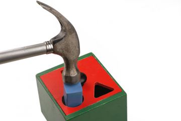 Hammer forcing square peg into round hole