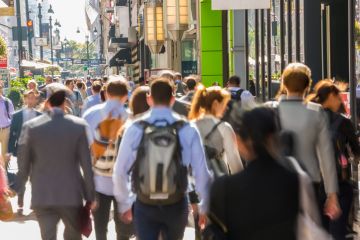 Commuters and pedestrians on busy pavement, Central Manhattan, New York, USA