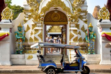 Tuk tuk in front of the entrance of Wat Chedi Luang, Chiang Mai, Thailand,