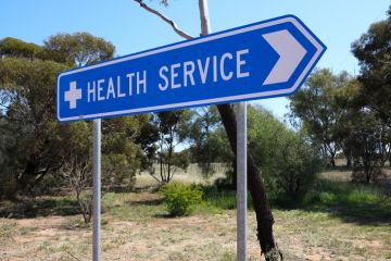 Directional road sign, to health services, small rural Outback town in Western Australia Directional road sign, to health services, small rural Outback town in Western Australia