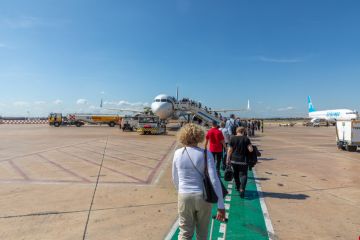 Lufthansa jet ready for boarding with passengers embarking the aircraft at Valencia.