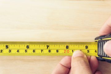 Hand Holding A Tape Measure Hand Holding A Tape Measure