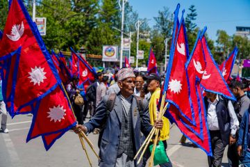 Pro-monarchy demonstrators waving national flags during a rally in Kathmandu, Nepal, in May 2025