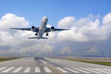 Airplane ascends into the sky after leaving the runway