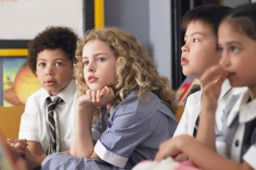 Thoughtful elementary students sitting in classroom Thoughtful elementary students sitting in classroom