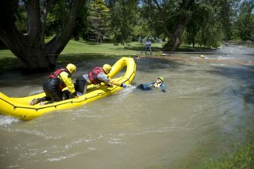 A rescue team readies to pull a mock victim to safety during a Swift Water Rescue training exercise. A rescue team readies to pull a mock victim to safety during a Swift Water Rescue training exercise.