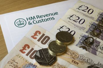 A HMRC letter head surrounded by British bank notes and coins