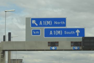 A road sign pointing to the north of England