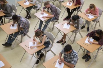 Elevated view of students writing their GCSE exam.