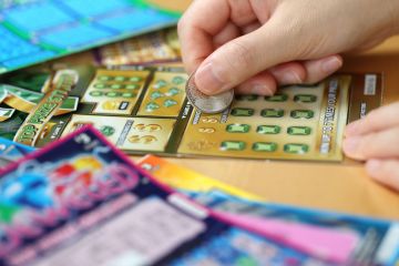 Woman scratching lottery ticket called Monopoly