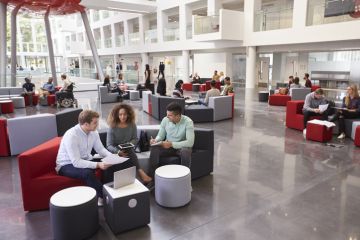 Students sitting in a university atrium