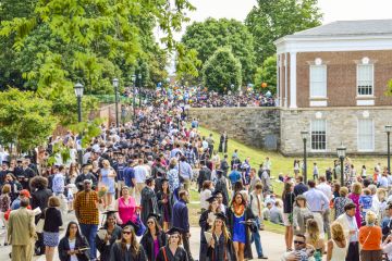  Crowd of people walking by amphitheater at graduation ceremony at University of Virginia