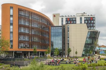 people relaxing on the grounds of De Montfort University people relaxing on the grounds of De Montfort University