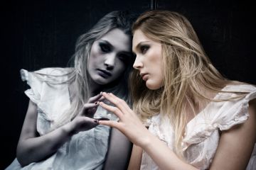 A woman looking at herself in the mirror