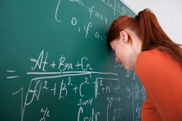 Student leaning head on blackboard Student leaning head on blackboard