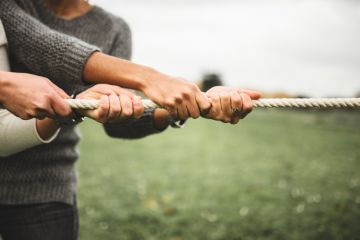 Two people taking part in a tug of war