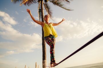 Teenage girl balancing on slack line Teenage girl balancing on slack line