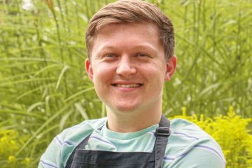 Josh Smalley in an apron that says University of Leicester Josh Smalley in an apron that says University of Leicester