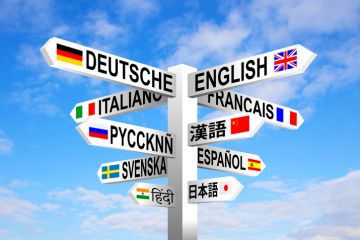 A signpost with the names of different languages on it A signpost with the names of different languages on it