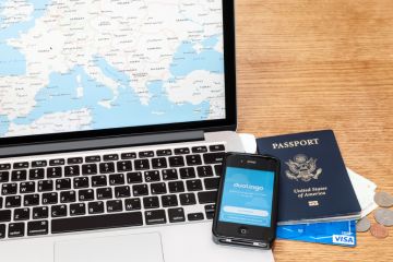 Preparing to travel Laptop, passport, phone and credit card for travelling