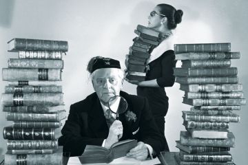 Librarians with piles of books Librarians with piles of books