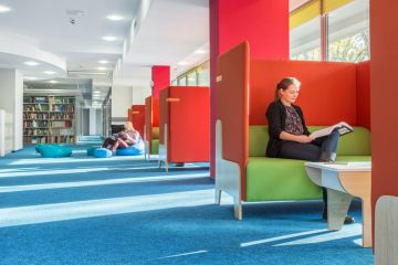 Library with individual study area with red partition and green sofa