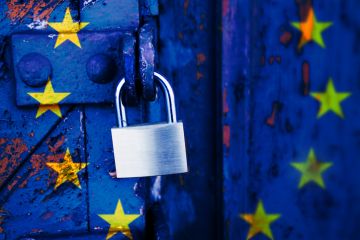 A padlocked door with the EU flag on it