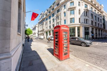 London, UK - June 26, 2018 Bank of china in business center architecture wide angle view with red telephone booth