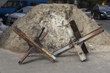 Lviv, Ukraine - March 10, 2022. Daily life during the war. Czech hedgehogs (anti-tank obstacles) on the city street.